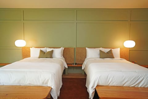 Stretch out on twin beds in a calm, modern room.