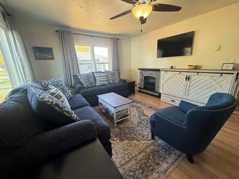 Living room with Queen Murphy bed, and fireplace.