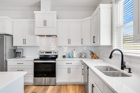 Kitchen - fully equipped for cooking, dining, and gathering around meals.