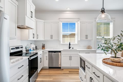 Kitchen - fully equipped for cooking, dining, and gathering around meals.