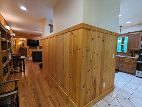 Photo showing the layout between the kitchen, hallway, and living room. 