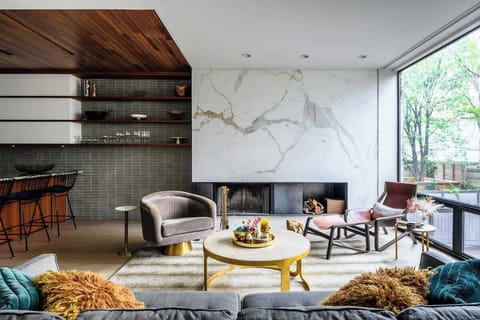 Glam, but comfortable, living room with stunning south-facing views of a lush garden and a striking marble fireplace.