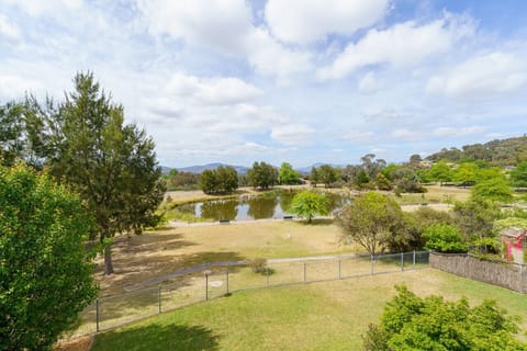 Enjoy sweeping views from the balcony, offering a serene outlook over the backyard and pond.