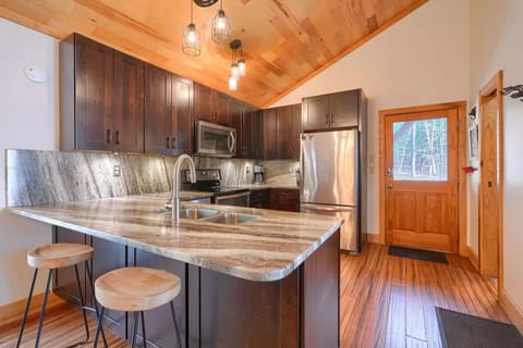 Well-stocked kitchen with granite counter tops, breakfast bar, and SS appliances