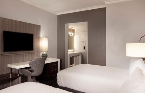 Unwind on crisp linens after a productive work session.