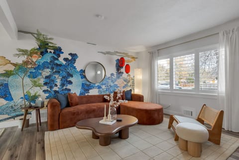 Japanese-themed living room with plush couch and beautiful background mural