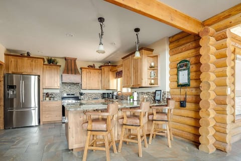 Kitchen bar with 3 luxury leather chairs.