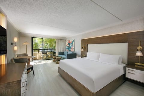 Unwind in a bright king room with breezy balcony views.