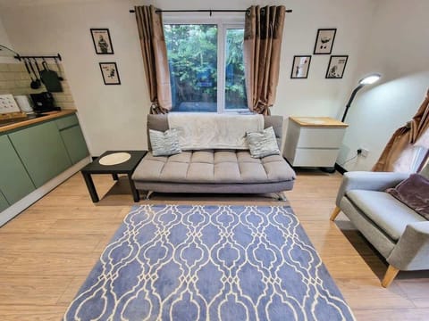 Relax in the spacious living room with a comfy sofa bed, perfect for extra guests.