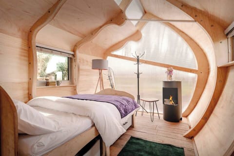 Bedroom with Window View Bright, cosy bedroom with a view outside, highlighting the natural light and modern touches - we provide eye masks. 