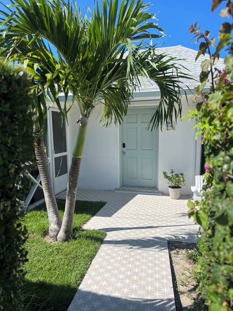 Walkway surrounded by lush vegetation that leads to the keyless entry villa