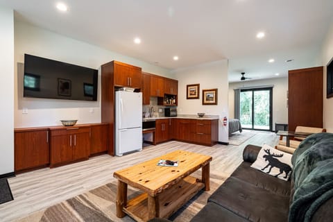 The 4th Bed & Bath is set up as a private suite on the first floor. Bed, Bath, Kitchenette, living area, and patio.