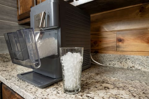 Sleek ice maker on granite countertop for chilled drinks during your vacation!