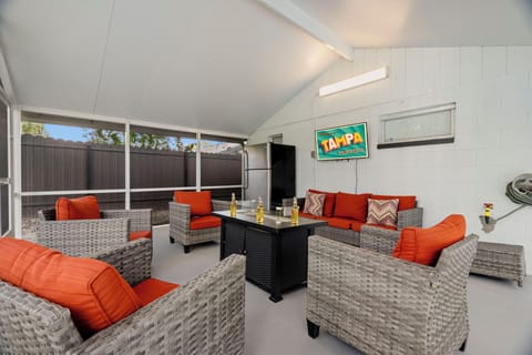 patio seating area with TV and fire pit table