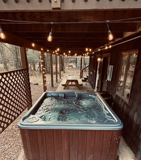 Hot Tub on the Ground Floor under the Deck and near the Picnic Table.   Gotta Love the Warmth.  Jump In! 