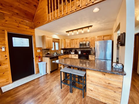 View of Kitchen from the Dining Room.    See the 2 Seat Breakfast Nook to keep the Chef Company?   Left a Door to the Deck.  Loft is peeking from Above! 