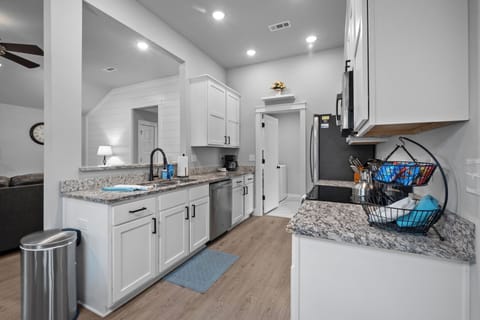 Pass through kitchen to laundry room & back door to patio. 