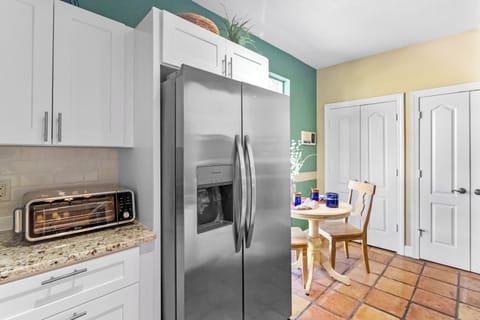 Kitchen and breakfast nook. Side by side refrigerator and Ninja toaster oven.