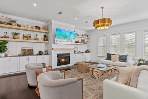 Relax in comfort with cozy seating, a crackling fireplace, and your favorite shows on the TV.