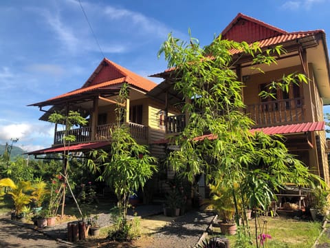 Timber clad building with wooden balcony and  balustrades