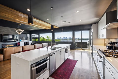 Kitchen 1: Enjoy panoramic city views from our airy living room with floor-to-ceiling windows, modern amenities, and a cozy gas fireplace.