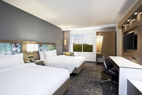 Unwind in bright double-queen room with calming window views.