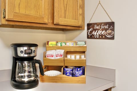 Stocked coffee bar with coffee, creamer, sweeteners. Cocoa and tea available too