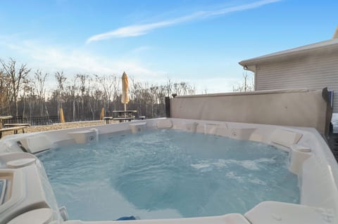 Soak in the outdoor hot tub surrounded by peaceful forest views.
