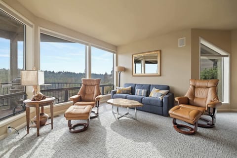 Bright open living space with sofa sleeper, gas fireplace, and Smart TV