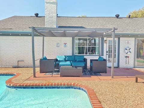 Lounge the day away poolside on the sunny back patio