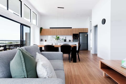 Relax on the comfy sofa with a soft throw, enjoy the big TV, and take in the peaceful nature views outside. The wood table adds the perfect Australian touch!