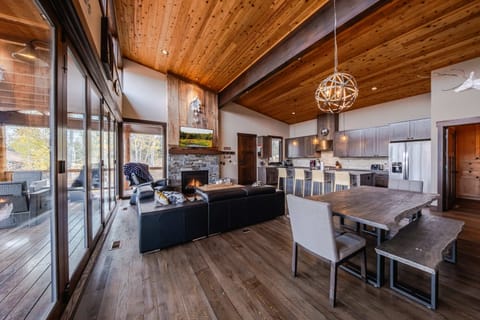 Bright living space with leather seating, fireplace, and Smart TV