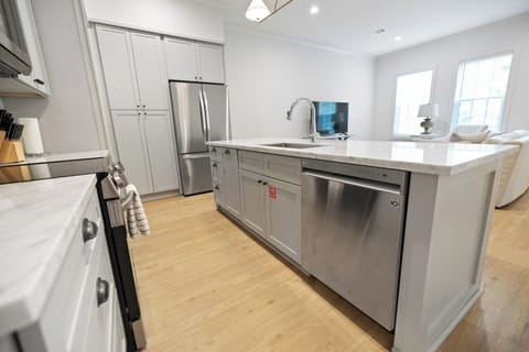 Dishwasher and pull-out trash bin for a clean, clutter-free kitchen.