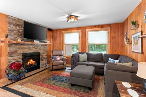 Our living room, featuring a charming fireplace, creates a snug ambiance that invites you to unwind and enjoy your time.