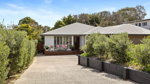 Long driveway with secure gate and landscaped garden