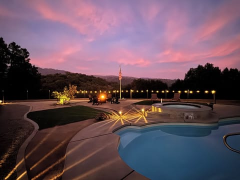 Backyard with pool, spa, fire pit, and game court