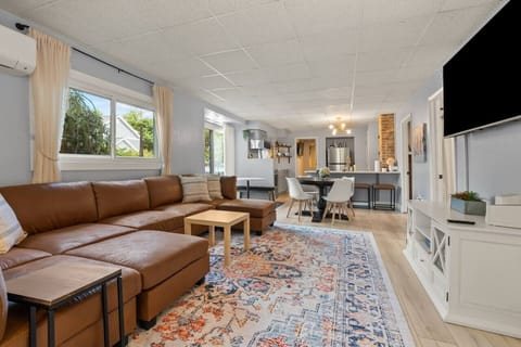 Relax in the spacious living room with a comfy couch and smart TV, the perfect spot to unwind after a day of adventures.