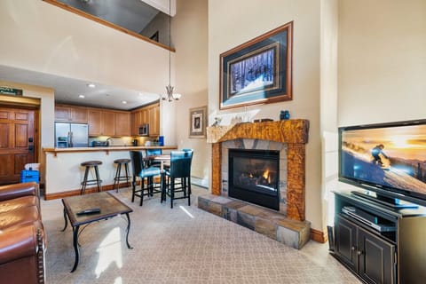 Stunning living room with a large fireplace and a view and open floor plan