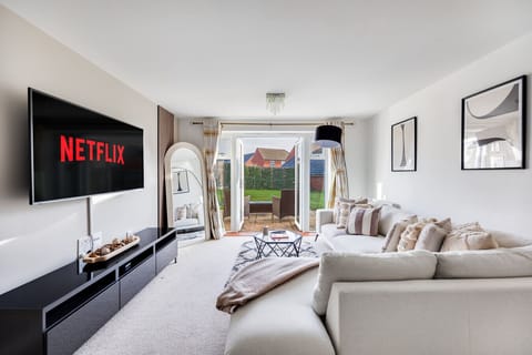 The living room features a large corner sofa and a 55'' Smart TV with Sky TV and Netflix subscriptions included