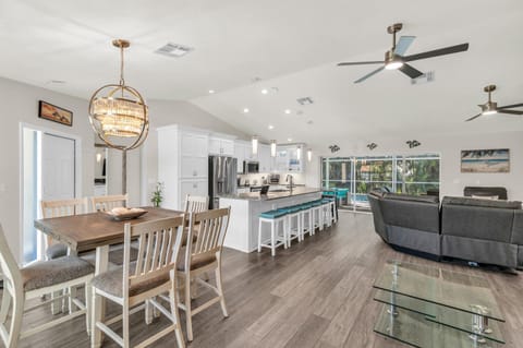 Wow factor! Open flow from house to outdoors with several seating areas 70" TV.