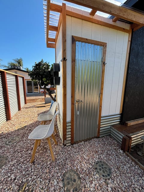 Outdoor enclosed shower, with hot water, towels provided.