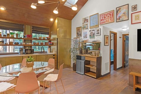 The open floorplan from kitchen, to dining room and living room make entertaining a breeze in this art-filled space. 