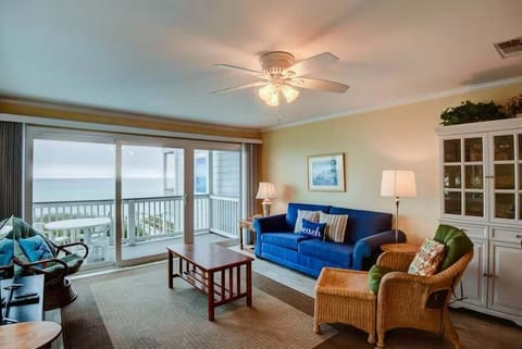 Open concept living area with stylish furnishings balcony access TV