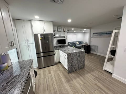 Cook and gather in this bright, airy kitchen, filled with natural light and modern touches for a warm and inviting atmosphere.