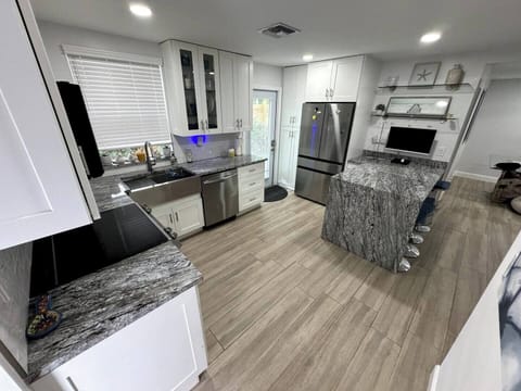 Cook and gather in this bright, airy kitchen, filled with natural light and modern touches for a warm and inviting atmosphere.