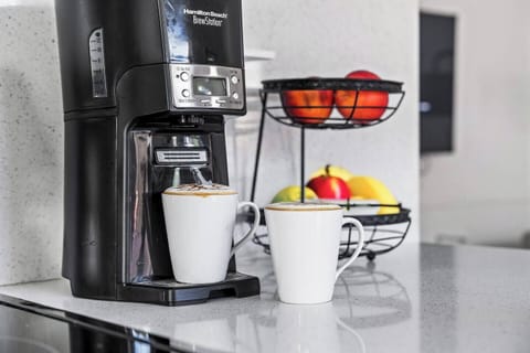 Cook and gather in this bright, airy kitchen, filled with natural light and modern touches for a warm and inviting atmosphere.