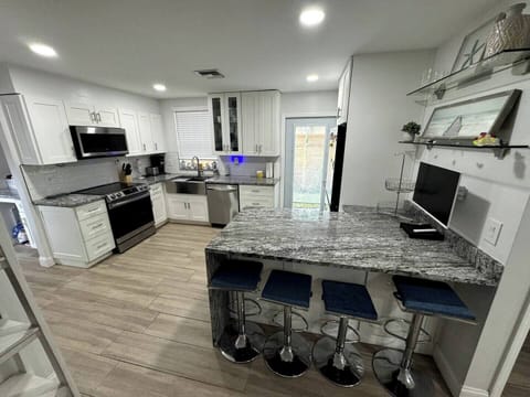 Cook and gather in this bright, airy kitchen, filled with natural light and modern touches for a warm and inviting atmosphere.