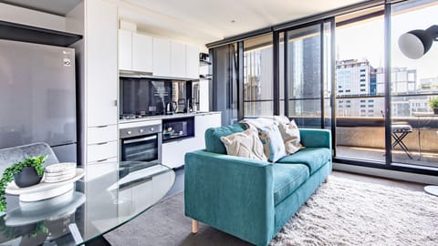 Open plan living with floor to ceiling windows and city skyline views