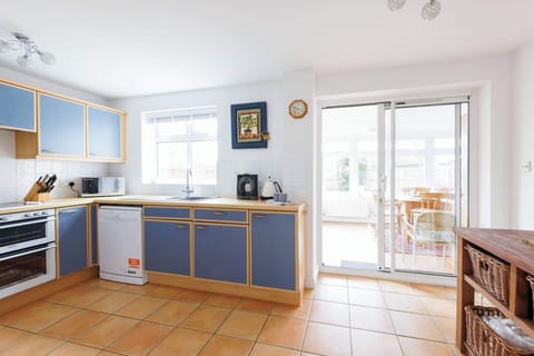 The kitchen is spacious with plenty of worktop space and cupboard storage.