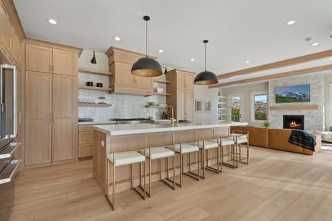 A massive island is the centerpiece of the large chefs kitchen